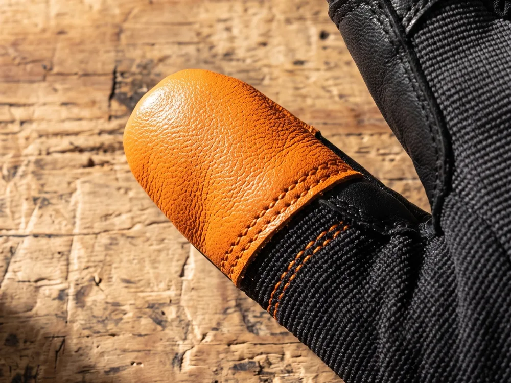 Render of the glove fingertip with a second layer of orange leather stitched on